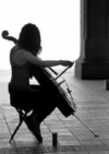 Cellist practices alone in the sunlight